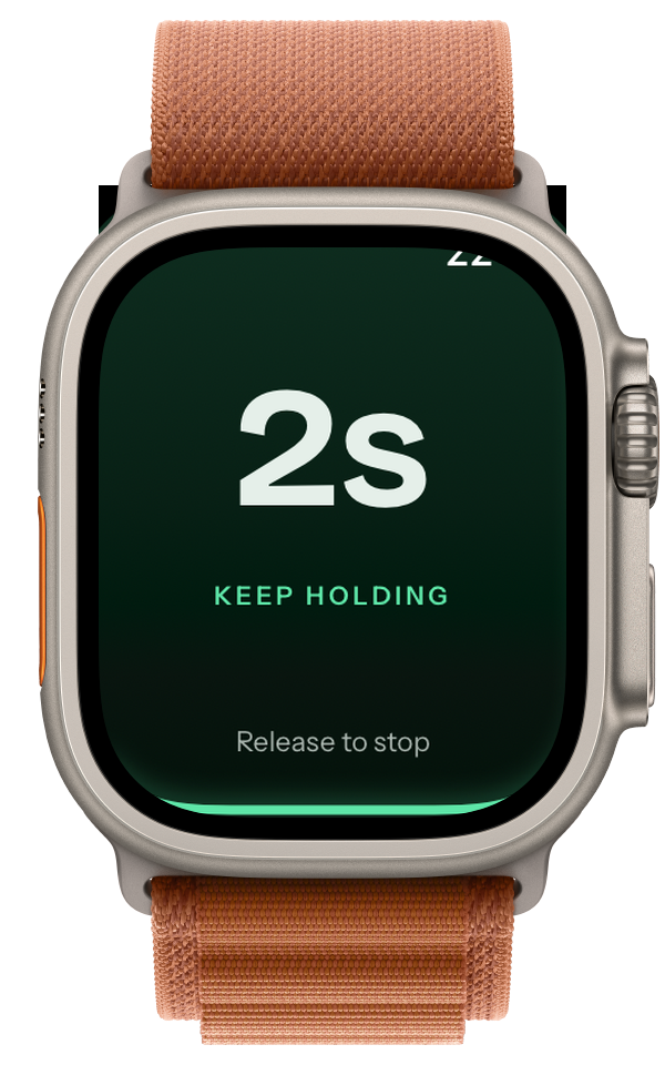 Apple Watch mid-hold, showing 2s and the words Keep holding.